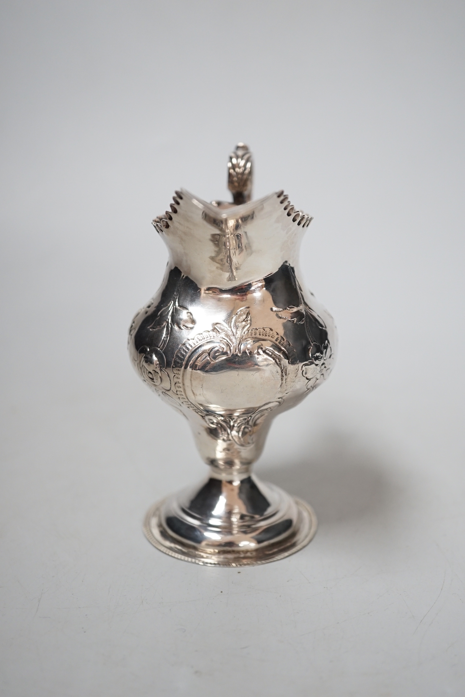 A George III silver inverted pear shaped cream jug, maker H?, London, 11.2cm, 75 grams.